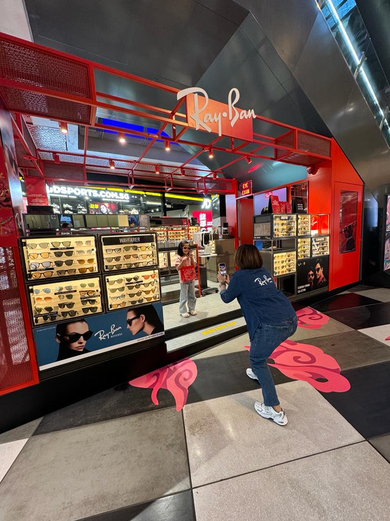 The vibrant red exterior of Ray-Ban Funan showcasing a wide array of sunglasses and optical frames.