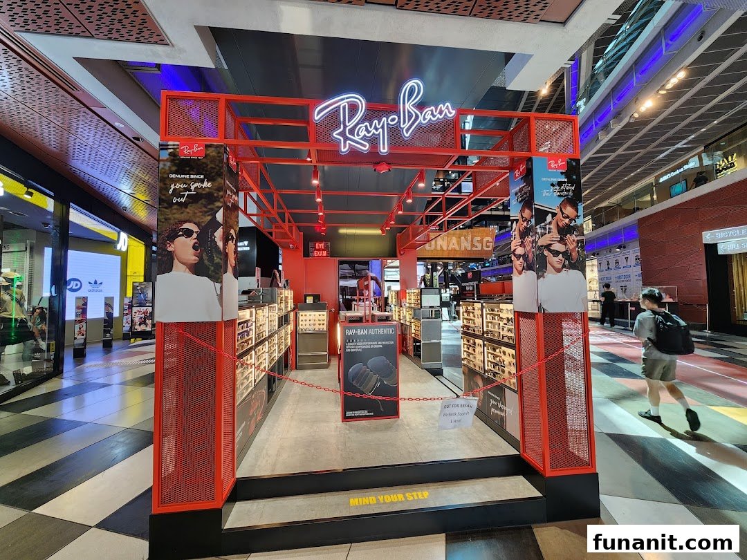 The Ray-Ban Funan shop entrance features prominent branding, eyewear displays, and promotional signage.