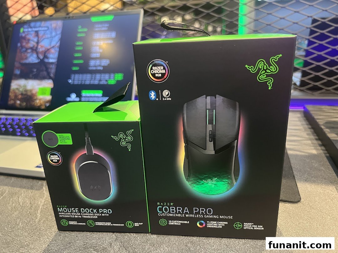 Two Razer product boxes, Mouse Dock Pro and Cobra Pro, displayed with a laptop.