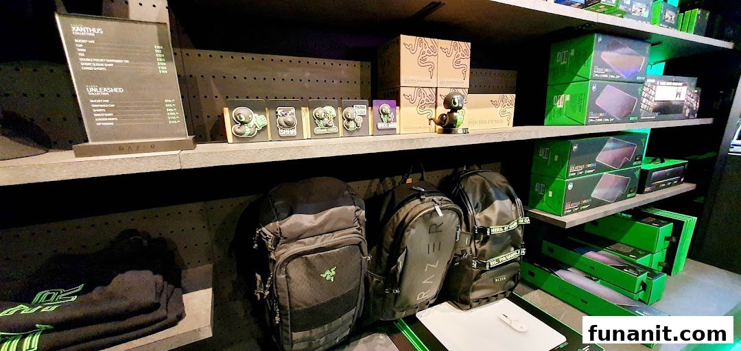 Interior view of RazerStore displaying gaming gear, apparel, and collectibles on shelves.