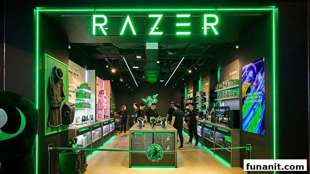The RazerStore Funan interior features vibrant green lighting, displaying gaming peripherals and electronics with staff present.