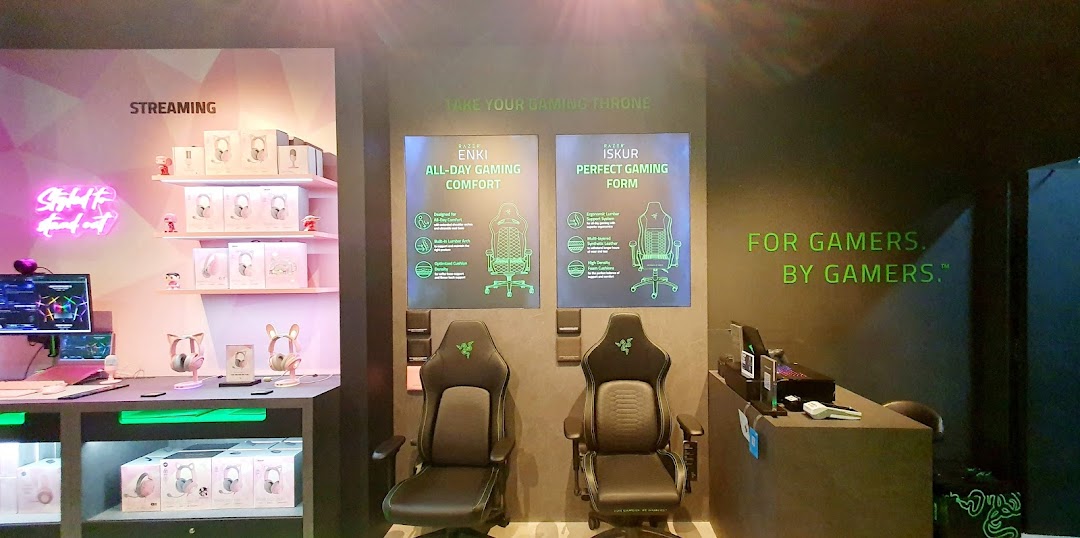 Interior view of RazerStore Funan showcasing gaming chairs, streaming gear, and product displays.