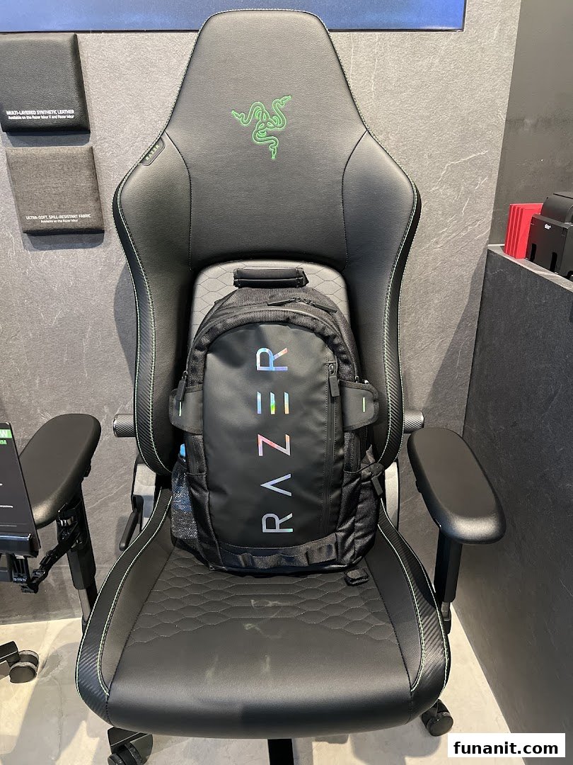A black Razer gaming chair with a Razer backpack on it, showcasing products in the store.