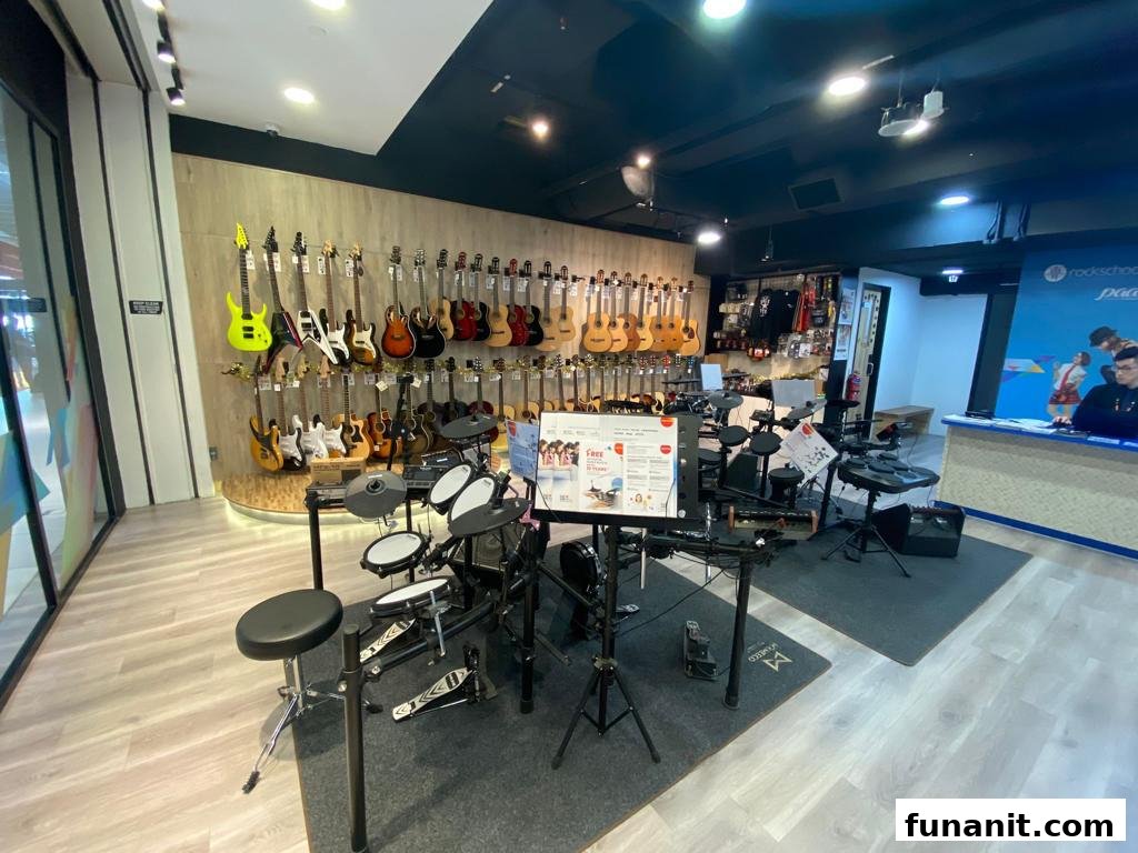 An interior view of Rockschool, RSL London, showcasing a wide array of guitars, ukuleles, and electronic drum kits.