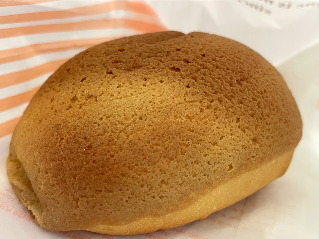 A close-up shot of a freshly baked, golden-brown Rotiboy coffee bun.
