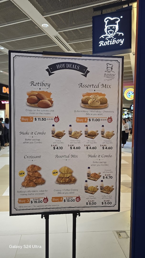 A menu board for Rotiboy showcasing hot deals and combo offers on their signature buns and croissants.