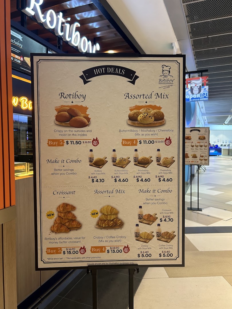 A menu board for Rotiboy displaying hot deals and combo offers for buns and croissants.