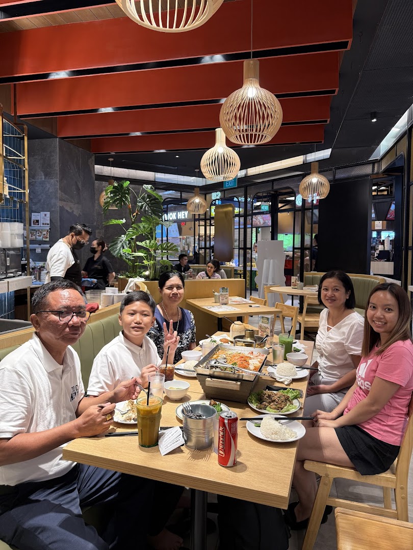 A group of diners enjoying a meal together at Sanook Kitchen, featuring a hotpot and various dishes.