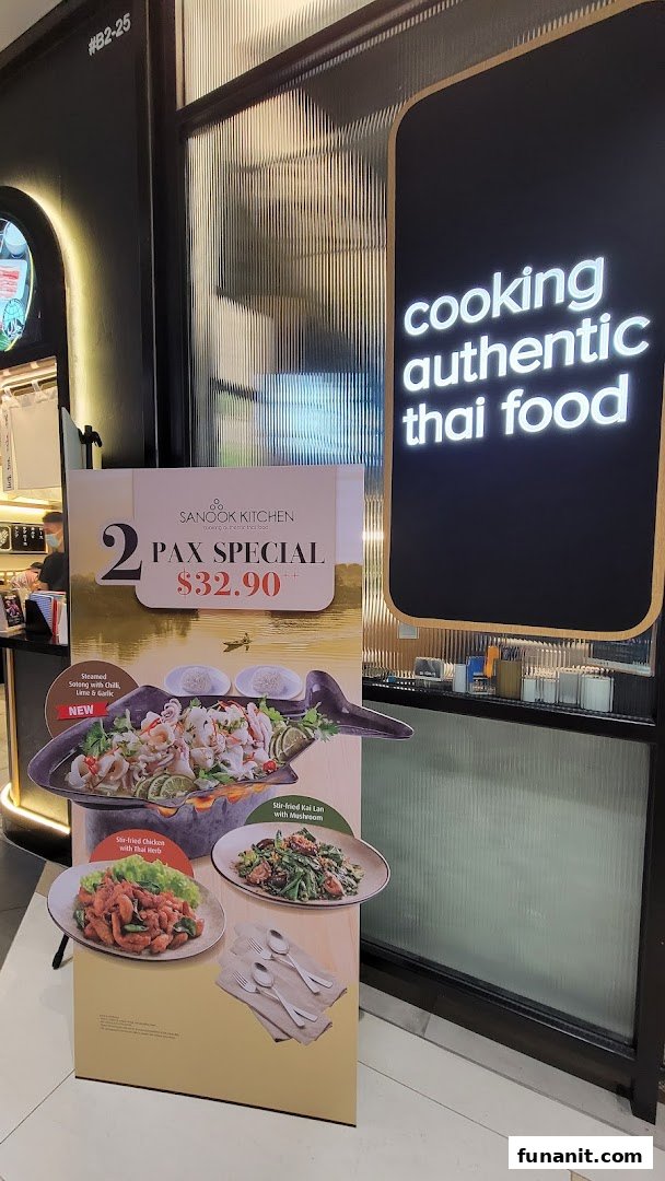 A promotional stand for a 2 Pax Special at Sanook Kitchen's entrance, featuring Thai dishes.