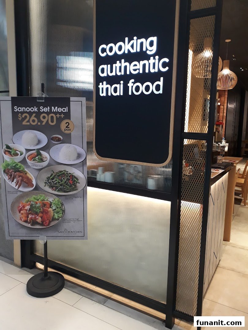 A promotional stand displaying Sanook Kitchen's set meal offer outside the restaurant.