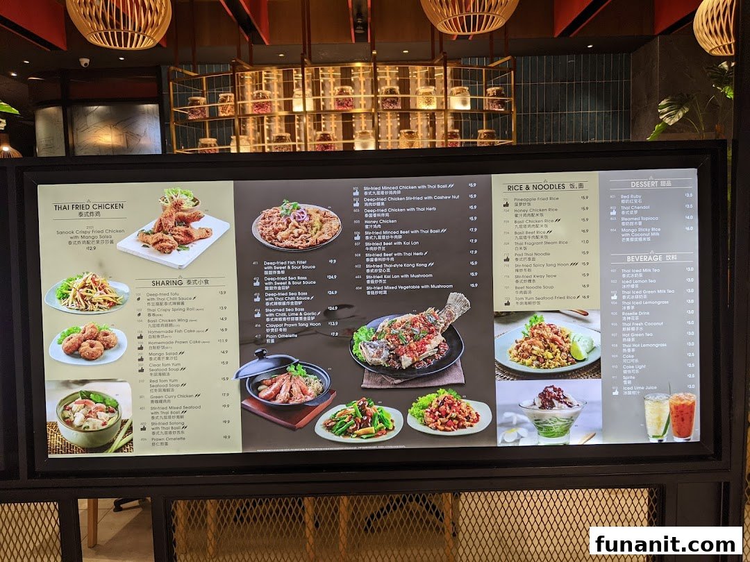 A vibrant digital menu board showcasing a variety of Thai dishes and beverages with prices.