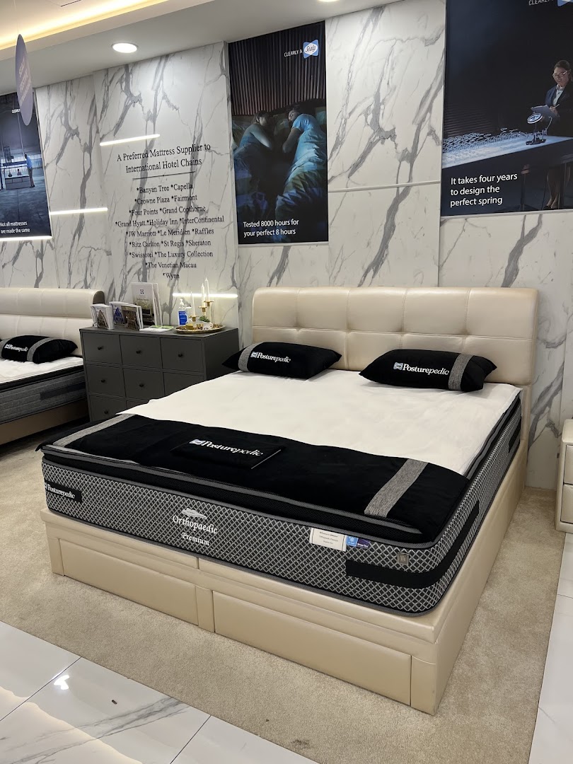 An interior view of Sealy Sleep Boutique showcasing a premium mattress display with promotional posters.