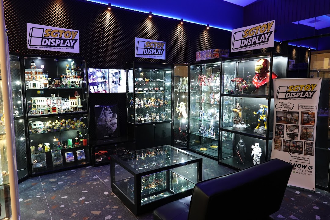 Interior view of SGTOYDISPLAY showroom featuring illuminated display cases filled with diverse collectibles and toys.