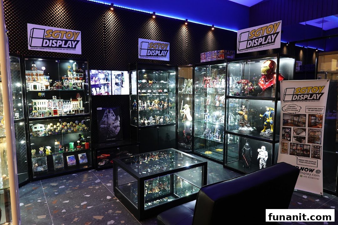 Interior view of SGTOYDISPLAY showroom featuring illuminated display cases filled with diverse collectibles and toys.