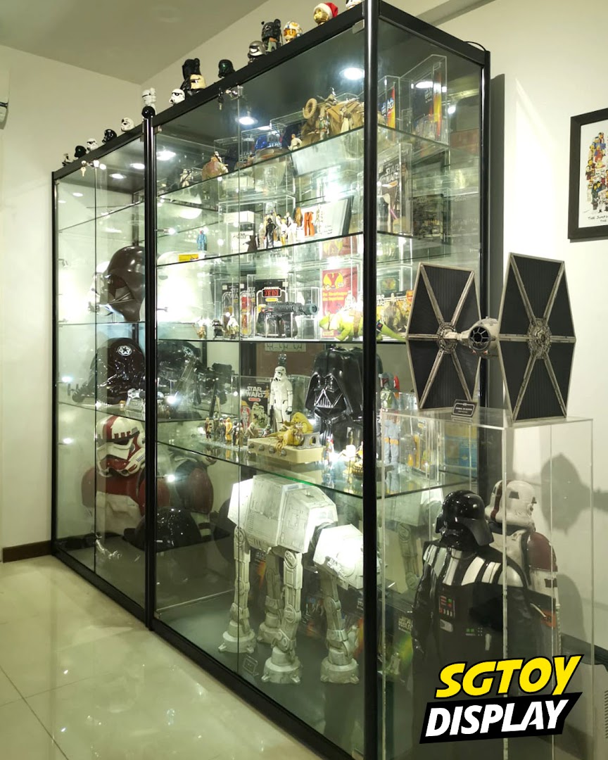 Large glass display cases showcasing an extensive collection of Star Wars figures and memorabilia.