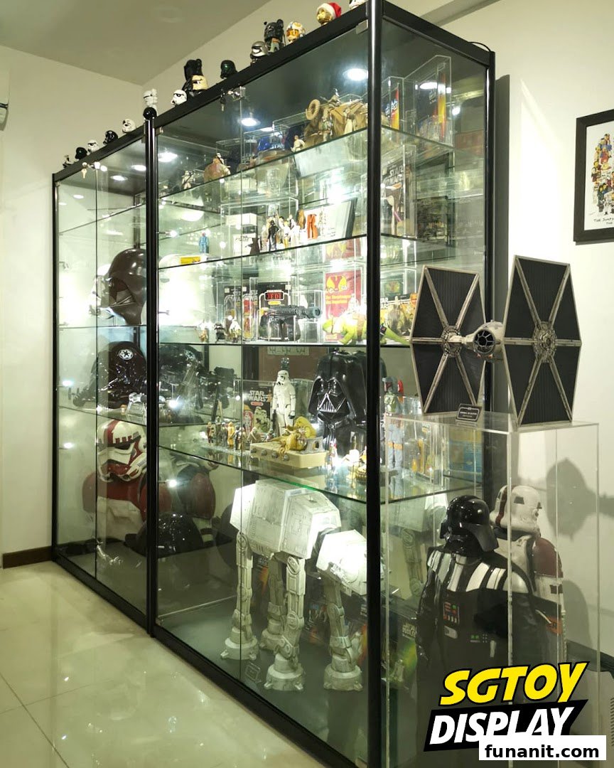 Large glass display cases showcasing an extensive collection of Star Wars figures and memorabilia.