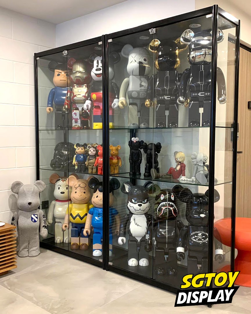 A vibrant display of collectible Bearbrick and art toys showcased in sleek glass cabinets.