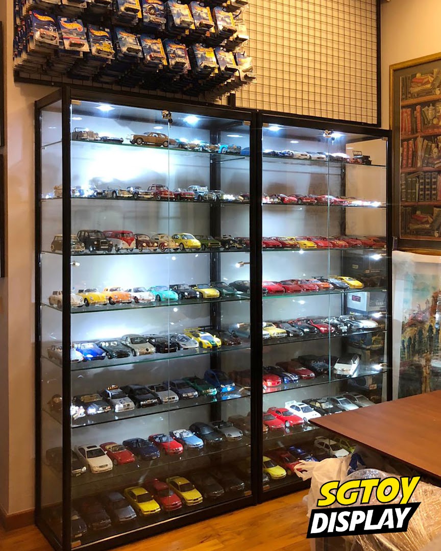 Brightly lit display cases showcase a vast collection of meticulously arranged toy cars and Hot Wheels.