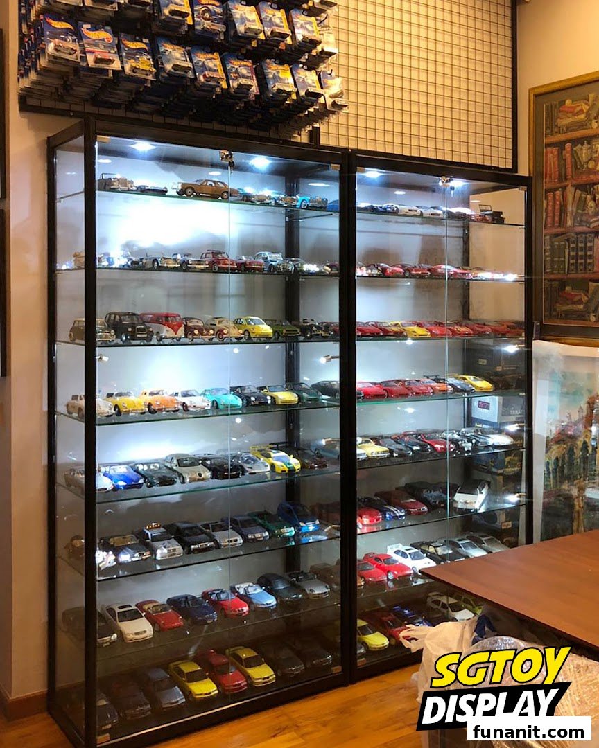 Brightly lit display cases showcase a vast collection of meticulously arranged toy cars and Hot Wheels.