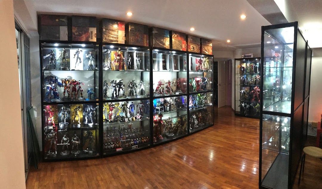 A room showcasing numerous collectible action figures and statues in illuminated glass display cases.