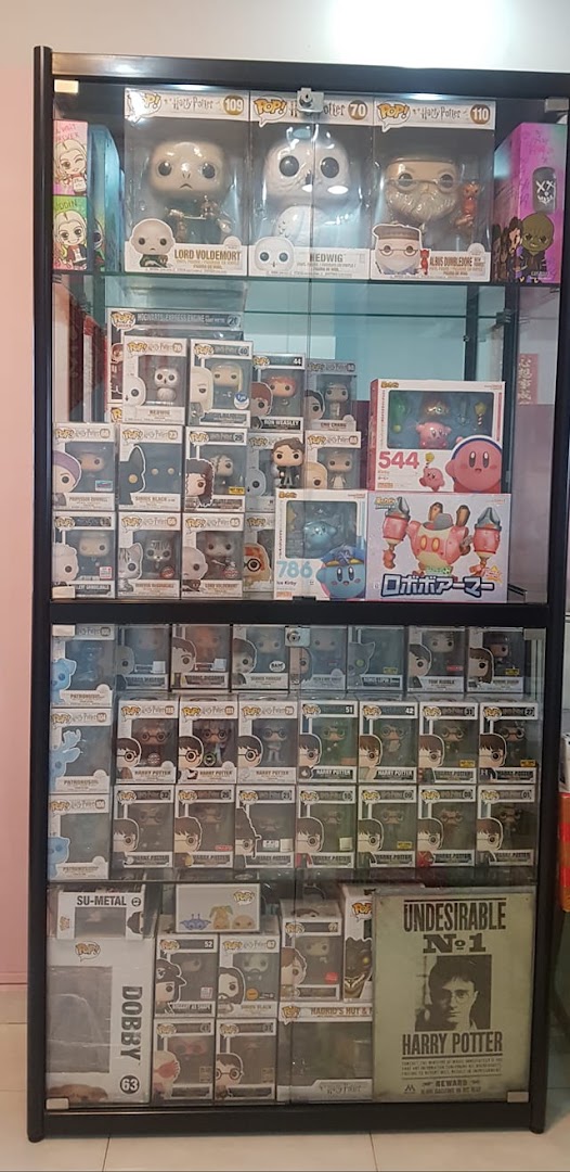 A display case showcasing a wide collection of Funko Pop! figures and other popular character collectibles.