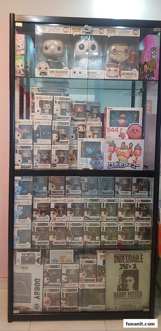 A display case showcasing a wide collection of Funko Pop! figures and other popular character collectibles.