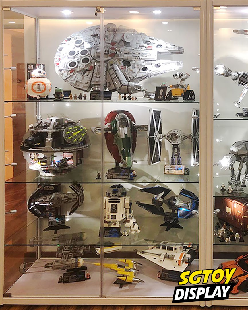 A display case showcasing an impressive collection of Star Wars LEGO models and other sci-fi toys.