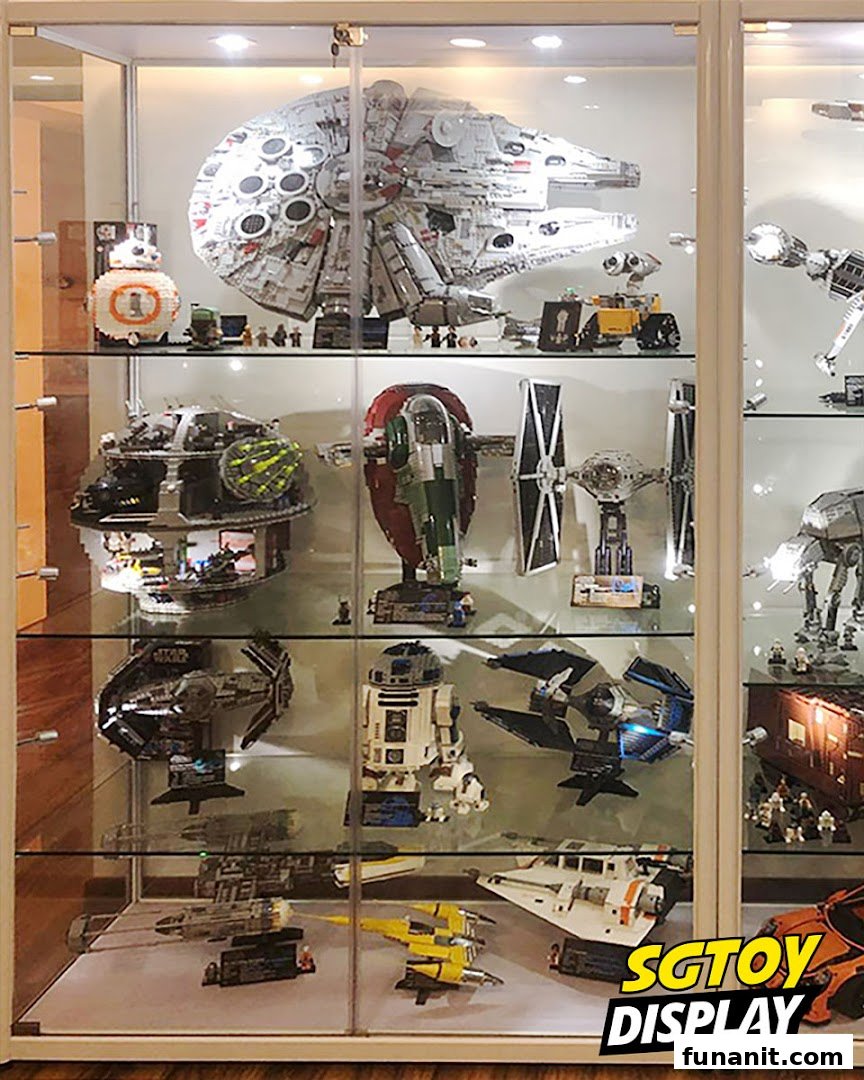 A display case showcasing an impressive collection of Star Wars LEGO models and other sci-fi toys.