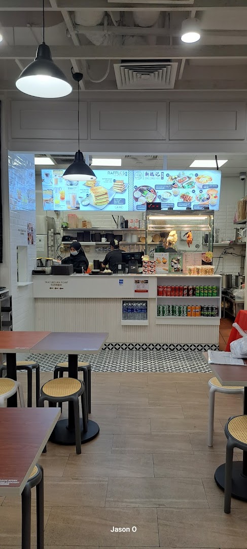 Interior view of Sing Swee Kee, showing the service counter, staff, and customer seating area.