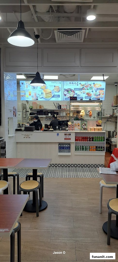 Interior view of Sing Swee Kee, showing the service counter, staff, and customer seating area.