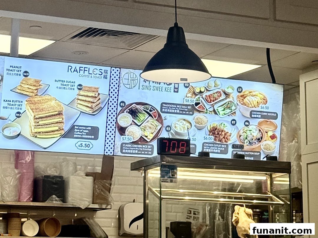 Digital menu boards displaying various toast sets from Raffles Coffee & Toast and main dishes from Sing Swee Kee.