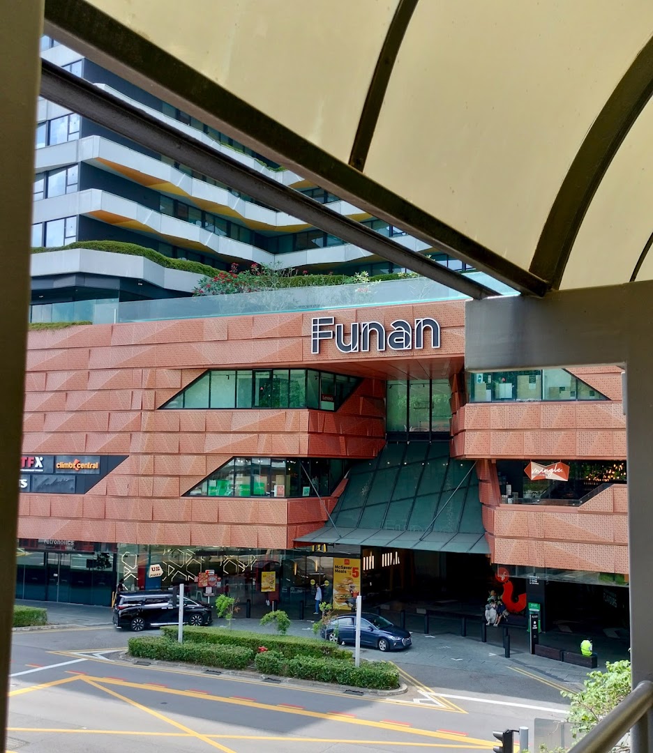 Exterior view of Funan mall, showcasing its unique architecture and street-level entrance.
