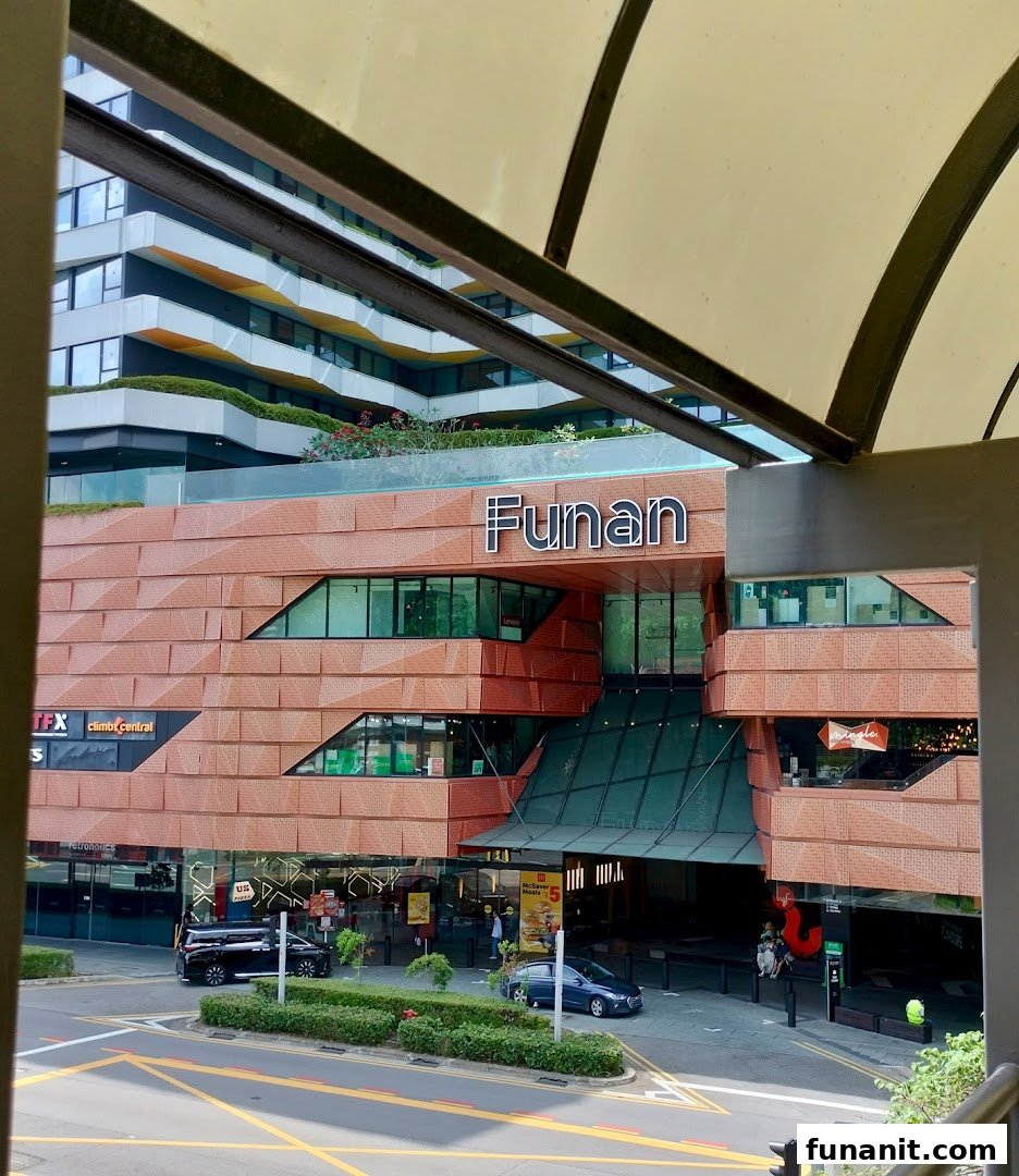 Exterior view of Funan mall, showcasing its unique architecture and street-level entrance.