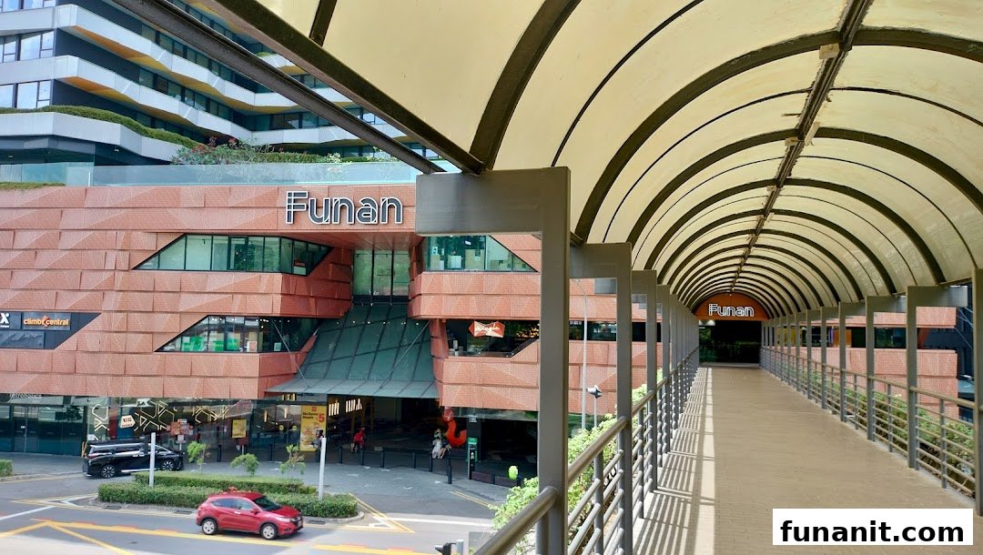 Exterior view of Funan mall with its distinctive architecture and an overhead pedestrian bridge.