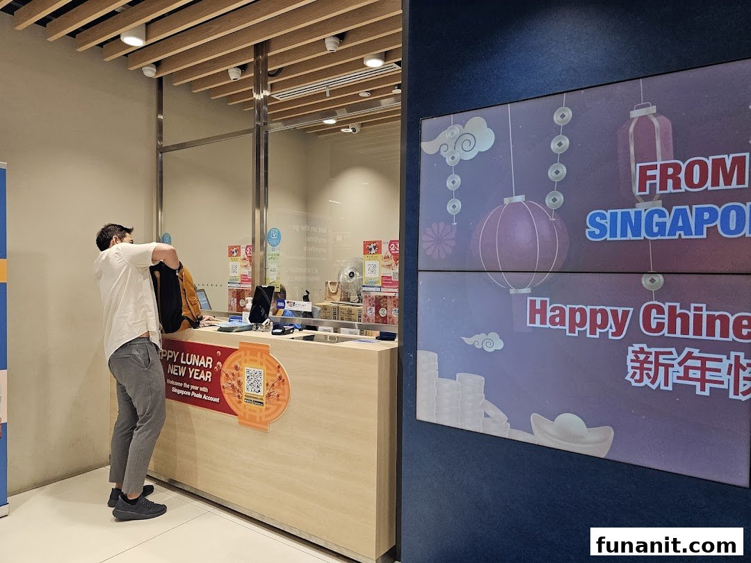 A customer at the counter of Singapore Pools Funan Branch with a festive digital display.