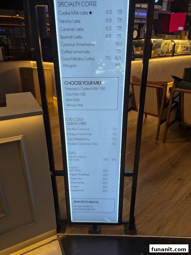 A brightly lit menu board displaying coffee, tea, and beverage options at Sinpopo Coffee.
