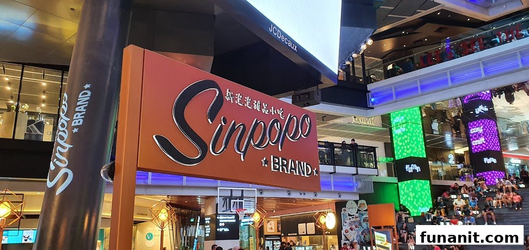 The Sinpopo Coffee shop sign prominently displayed within a bustling shopping mall environment.