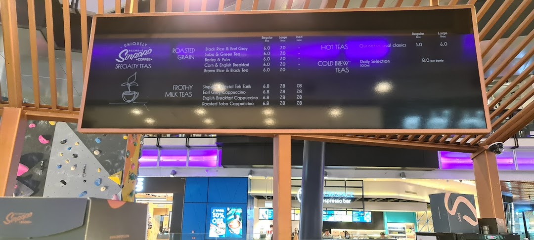 A menu board displaying specialty tea offerings and prices at Sinpopo Coffee.