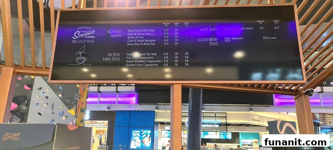 A menu board displaying specialty tea offerings and prices at Sinpopo Coffee.