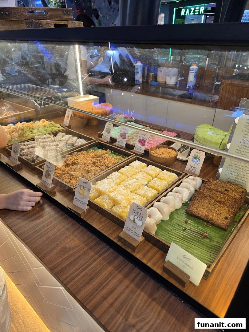 A vibrant display counter showcasing an assortment of traditional Singaporean desserts and pastries.