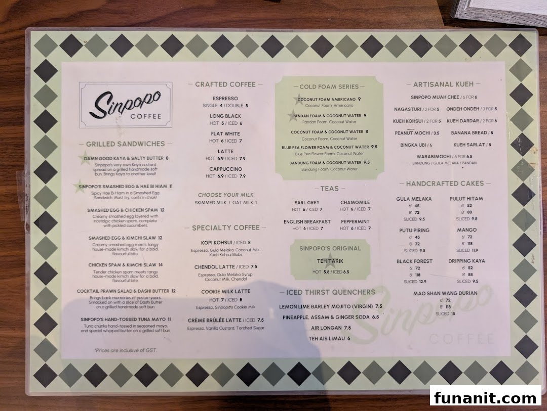 A detailed menu from Sinpopo Coffee, showcasing a variety of coffees, teas, sandwiches, kueh, and cakes.