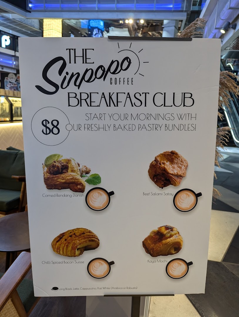 A promotional stand for Sinpopo Coffee's 'Breakfast Club' featuring pastry bundles and coffee options.