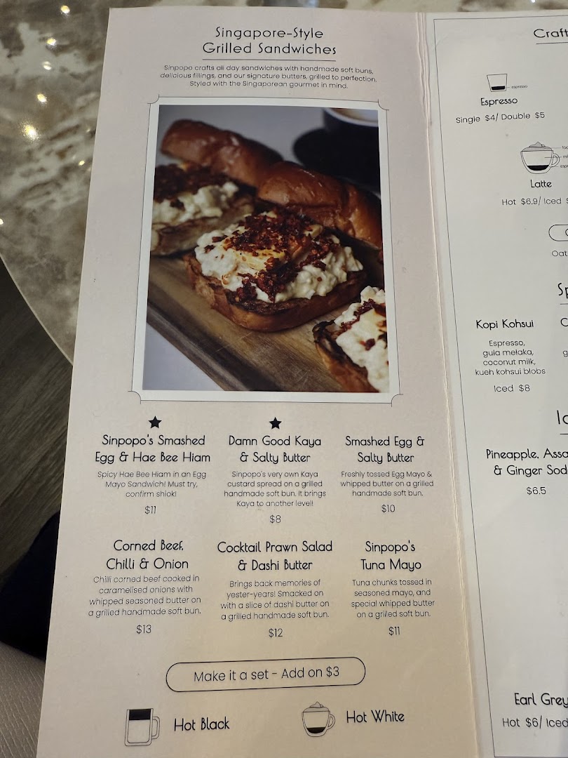A menu page from Sinpopo Coffee featuring Singapore-style grilled sandwiches and beverages.