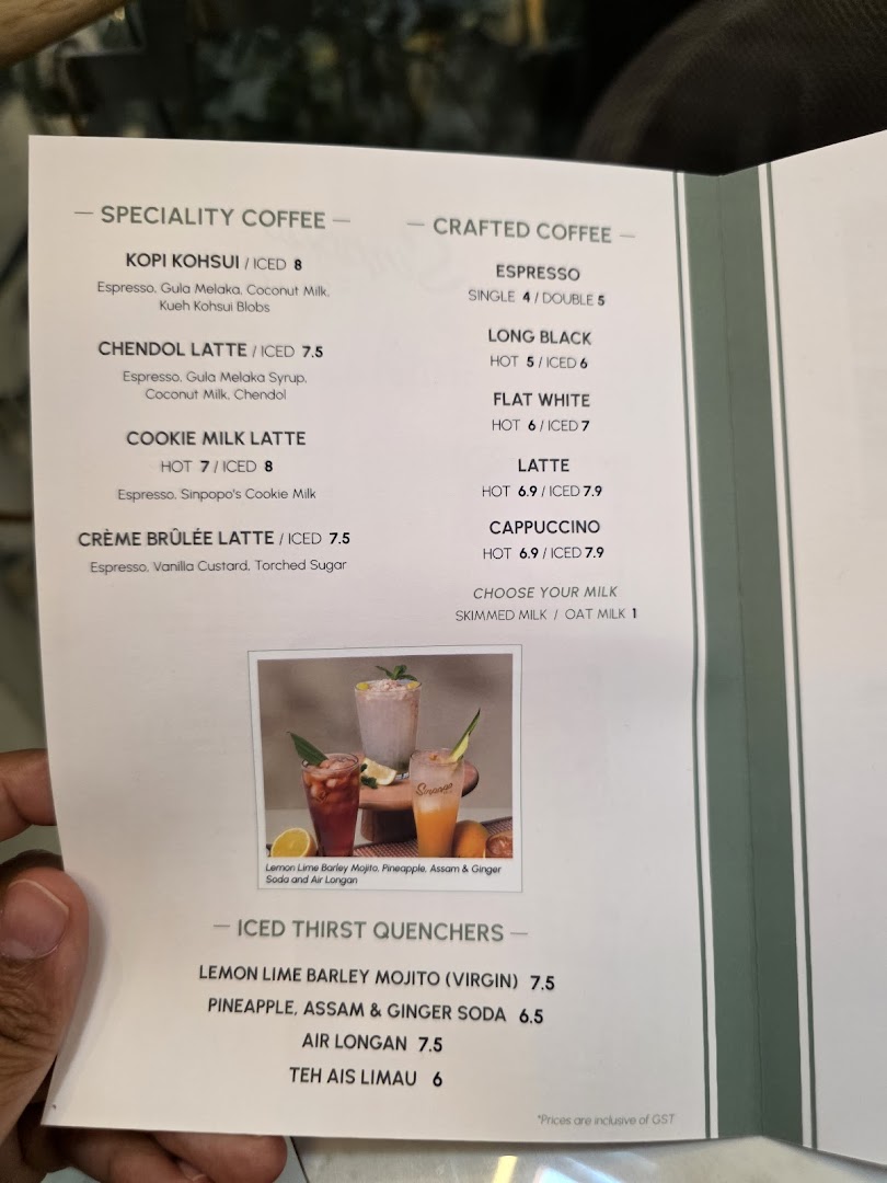 A close-up of Sinpopo Coffee's menu, featuring specialty coffees, crafted coffees, and iced thirst quenchers.