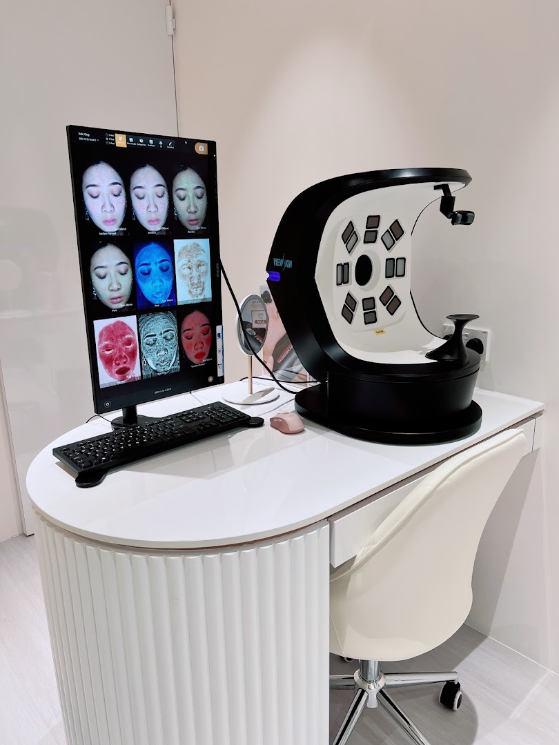 A modern skin analysis machine and monitor displaying detailed facial scans in a clean, white setting.