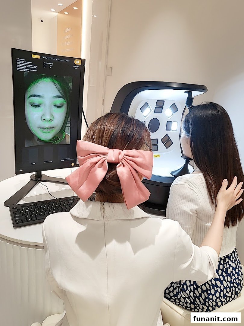 Two women engaged in a skin analysis session at Skin Belief, showcasing advanced skincare technology.