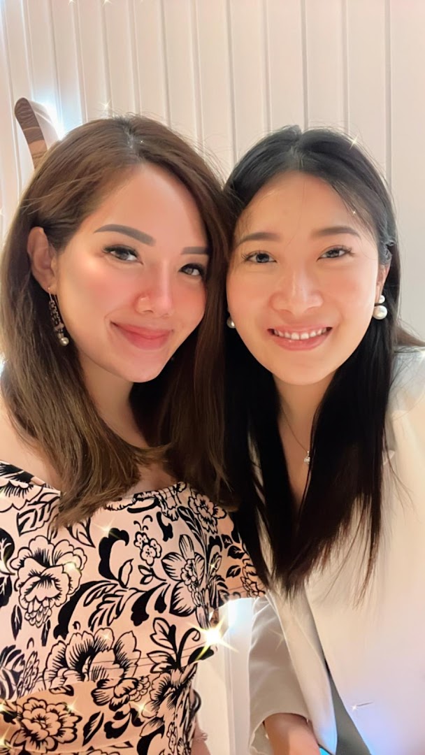 Two smiling women posing for a close-up photo, likely at Skin Belief.