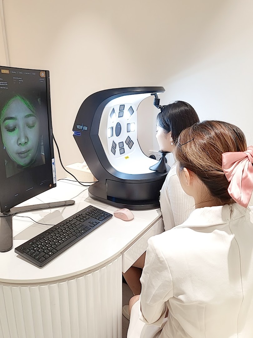 A customer undergoes a detailed skin analysis using advanced technology at Skin Belief.