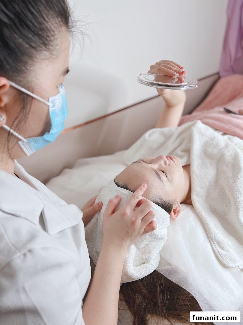 A client receives a relaxing facial treatment from a masked therapist at Skin Belief.