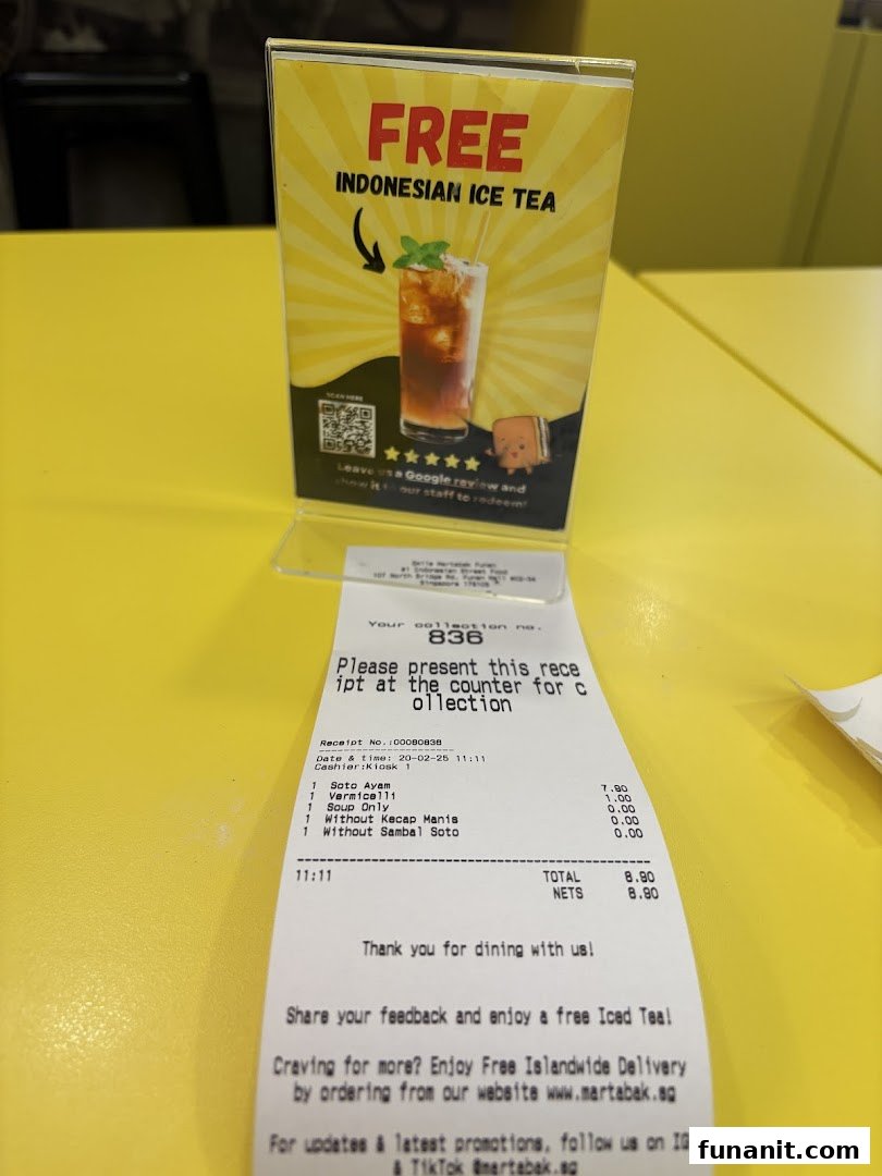 A promotional stand offering free Indonesian Ice Tea for Google reviews, displayed next to a customer receipt.